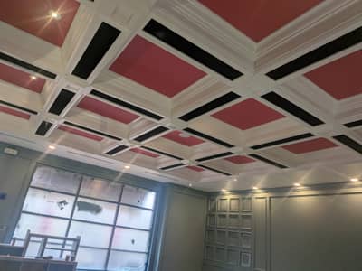 Garage interior with red-painted ceiling and geometric black and white trim pattern.