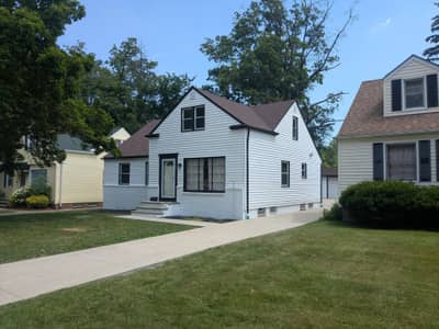Two-tone house exterior with gray upper level and white lower level siding.