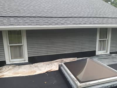Garage area with white siding and roof.