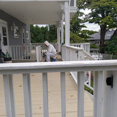 Deck with white railings and exterior house siding.