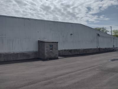 Commercial warehouse building with gray metal siding.