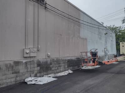 Commercial warehouse building with gray corrugated metal exterior.