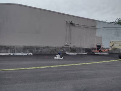 Commercial warehouse building with gray corrugated metal exterior.