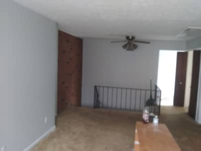 Interior room with brown wooden doors and beige tile flooring.
