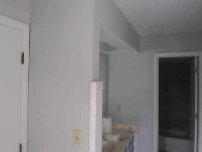 Interior room with white walls and multiple doorways.