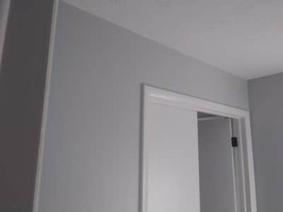 Interior room with white door frame and trim details.