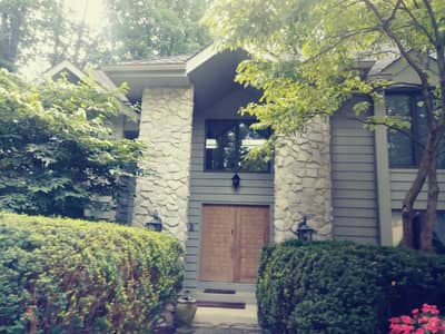 Navy blue painted house exterior with light colored trim and siding accents.