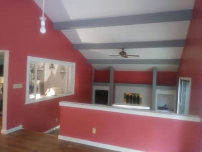 Red painted room with white trim, built-in cabinetry, and decorative wall treatment.